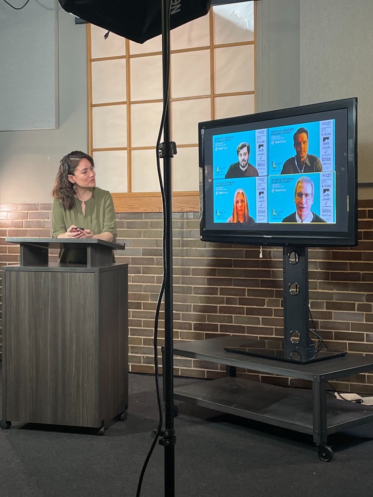Marisa Baylon Guillen stands at a podium during a professional event.